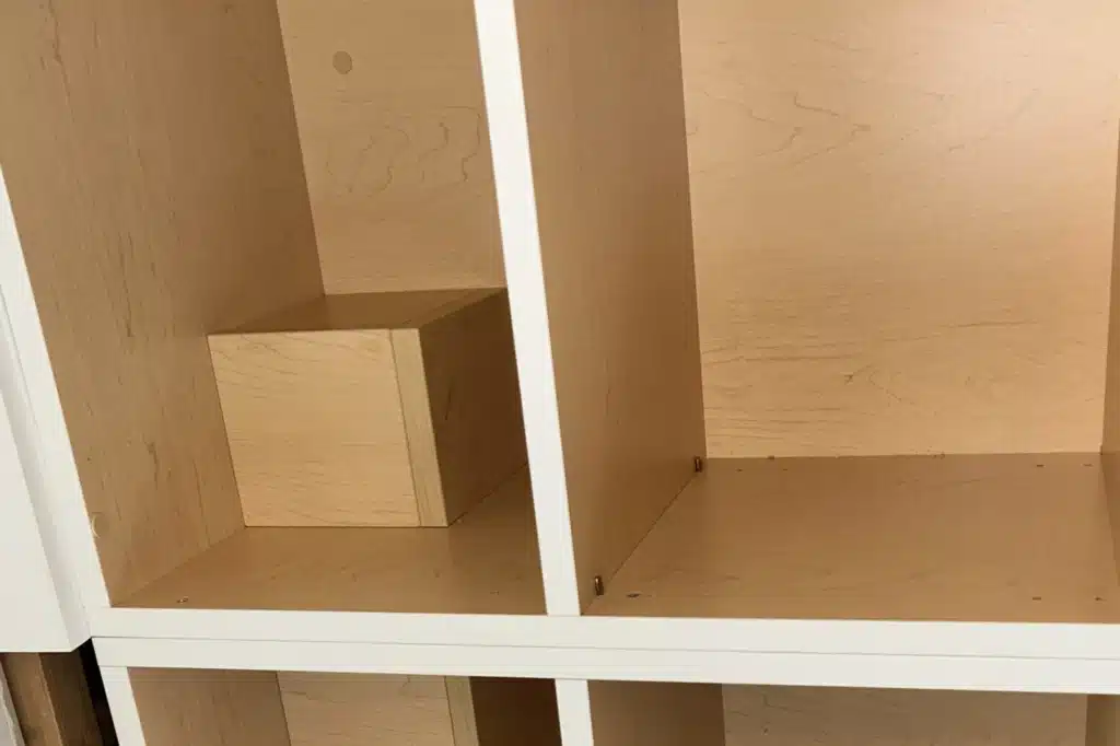 Custom kitchen cabinets in an Ontario home: a maple box built into the back corner of a cabinet compartment, enclosing the duct behind it so the cabinet can run to the ceiling.