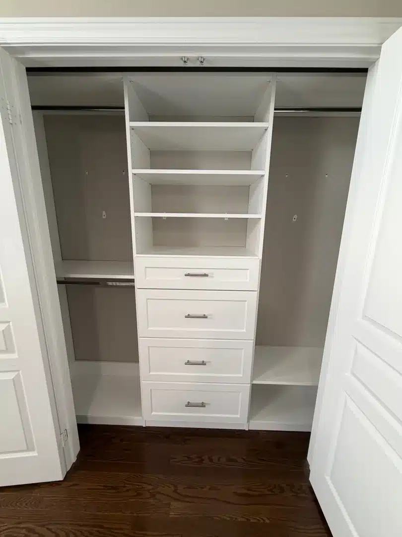 White reach-in closet in Vaughan with a four-drawer shaker stack, shelves above and hanging rods on both sides