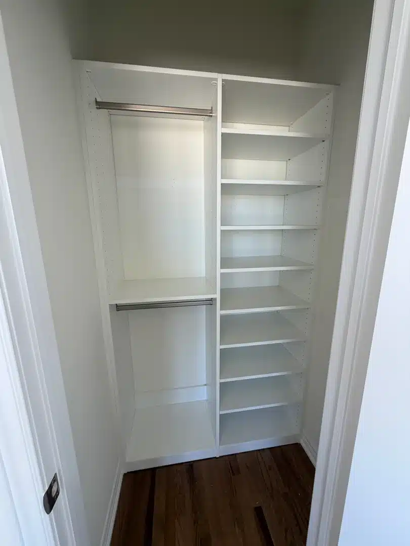 White reach-in closet in Markham with a shelf tower on one side and double hanging on the other