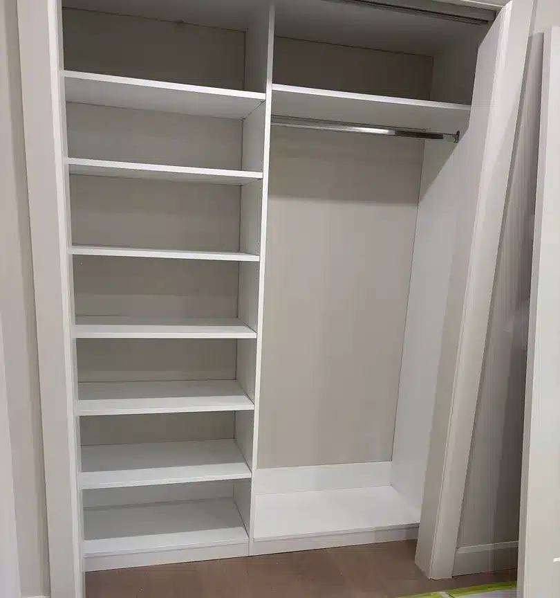 White reach-in closet in Midland with a full-height shelf tower beside a single hanging rod